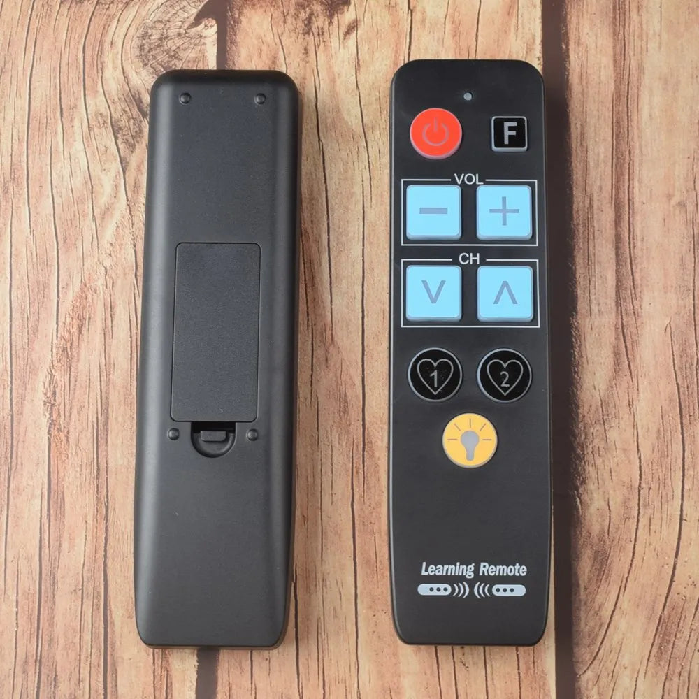 Big button remote control in hand — simplified 9-button universal TV remote for seniors