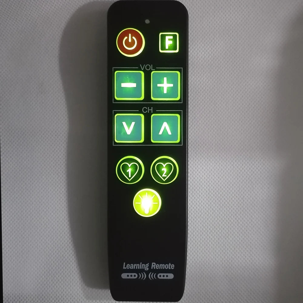 Large button TV remote showing backlit keys in dark — easy to see elderly remote control