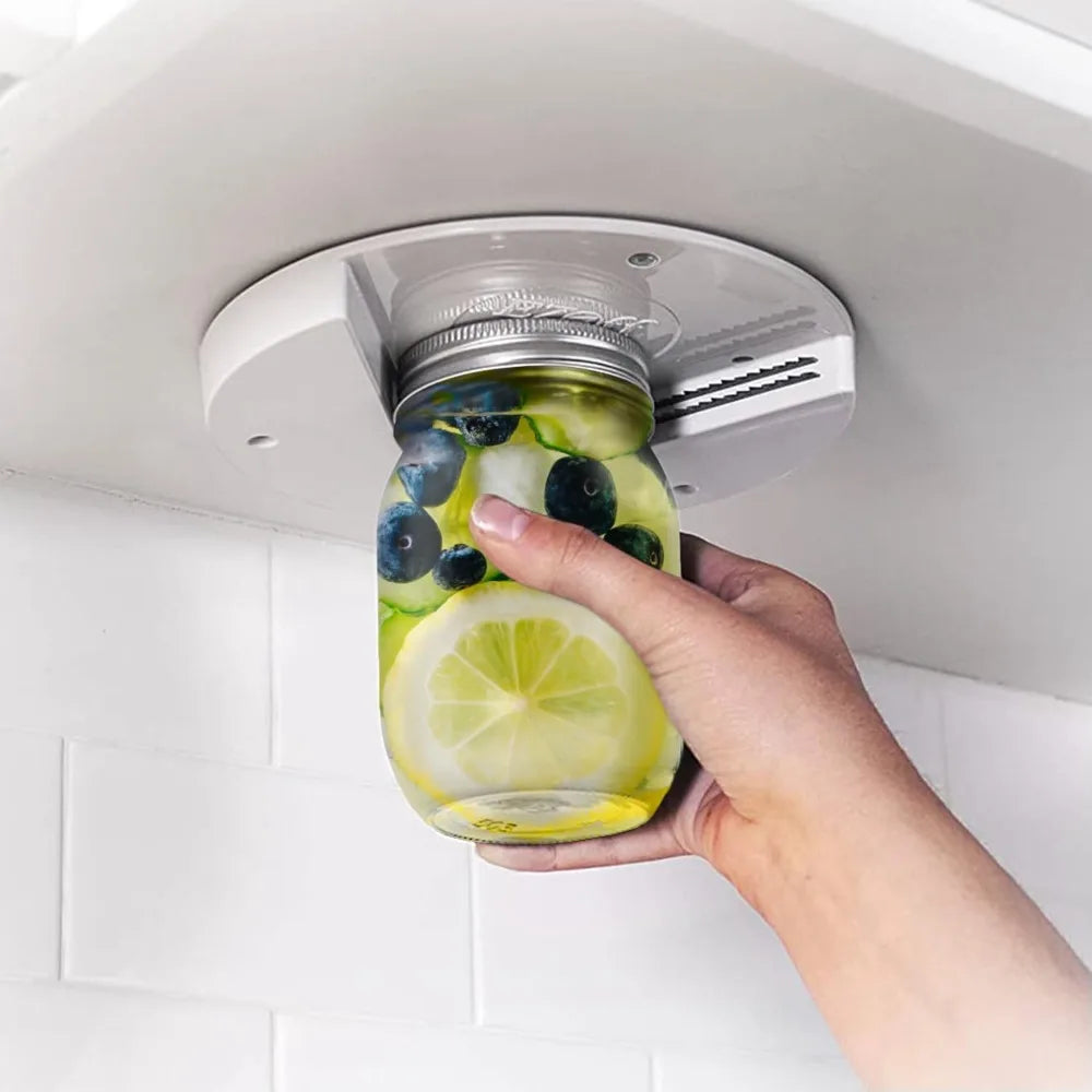 Under-cabinet jar opener mounted beneath kitchen cupboard — one-handed lid remover